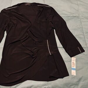 Black holiday blouse with ruched side and rhinestone accents, open arms.